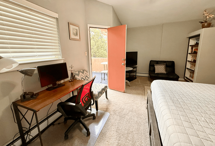working station, reading corner, and private balcony in master bedroom