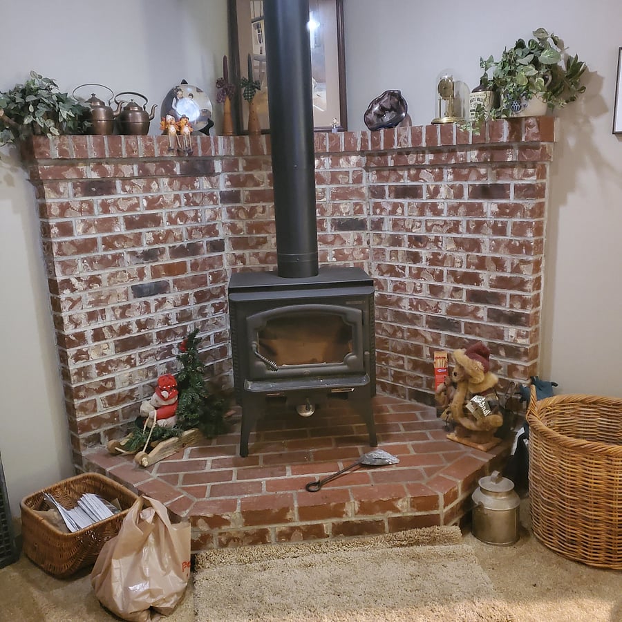 Woodburning fireplace in shared living room 
