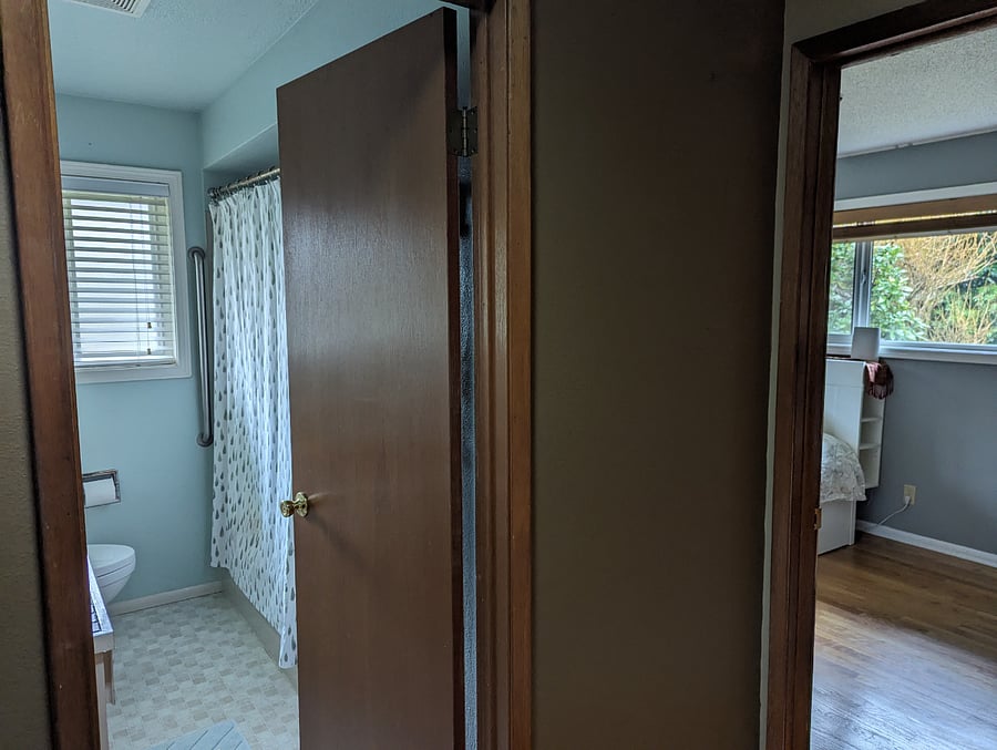 The room and the full bathroom from the hallway. The bedroom has a keyed lock.