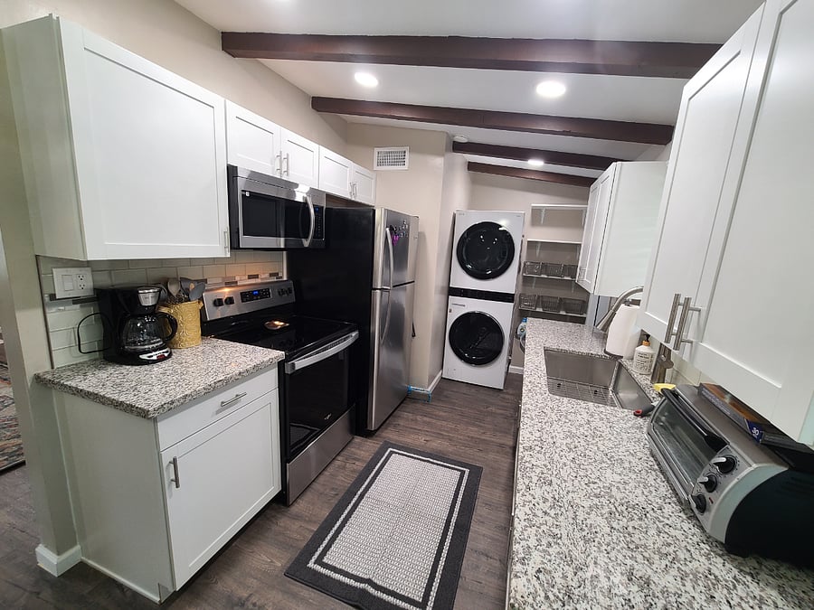 Our spacious and fully-stocked kitchen has plenty of storage space.