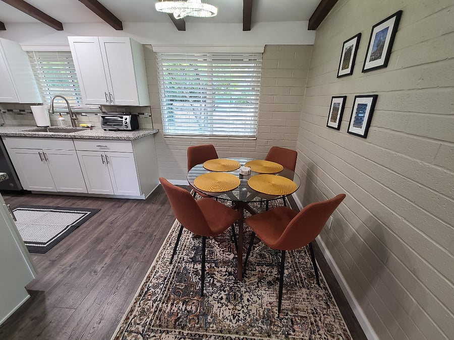 Roomy dining table with seating for four- can double as a work space.