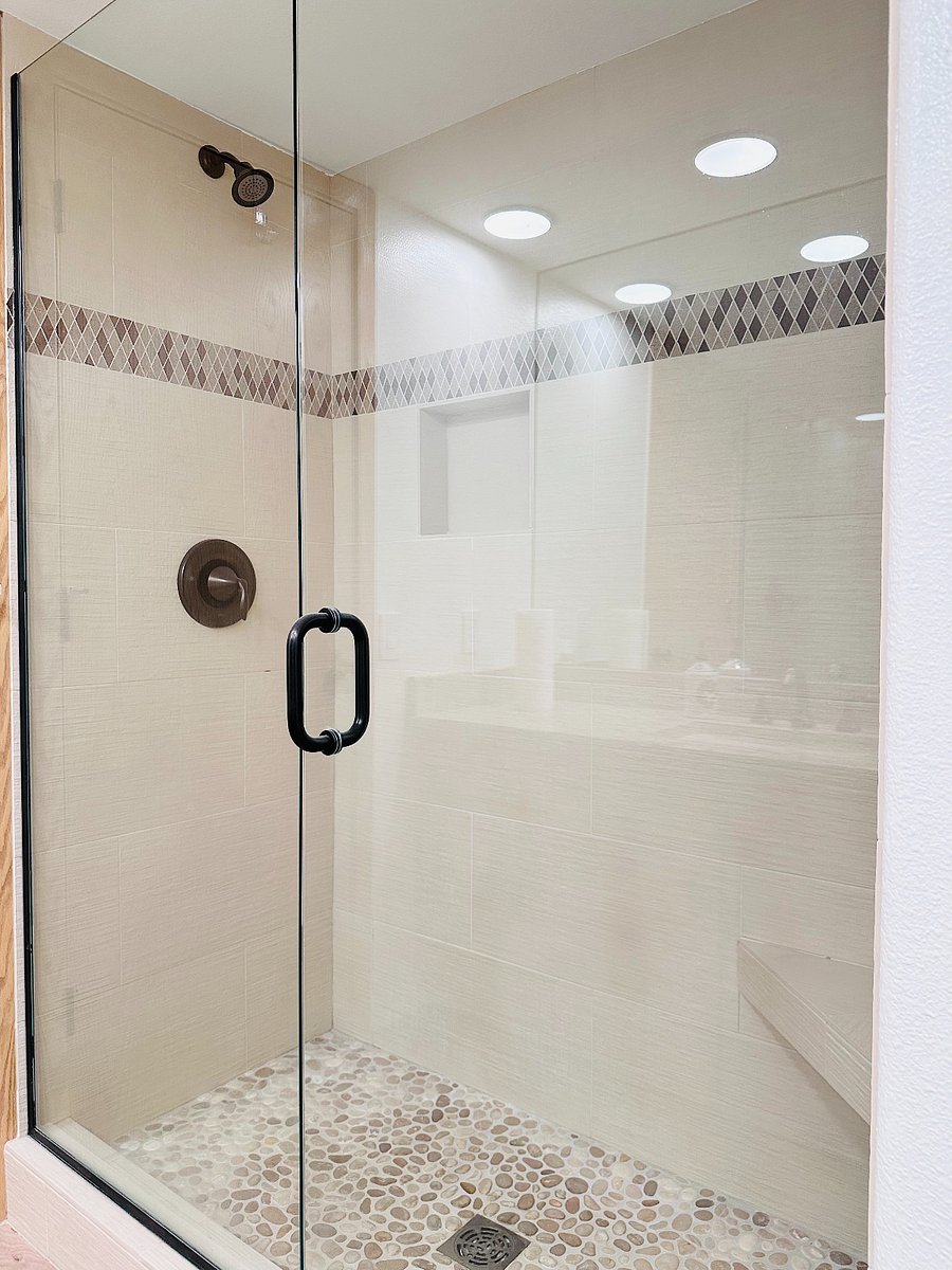 Modern bathroom with large mirror and ample light and space.