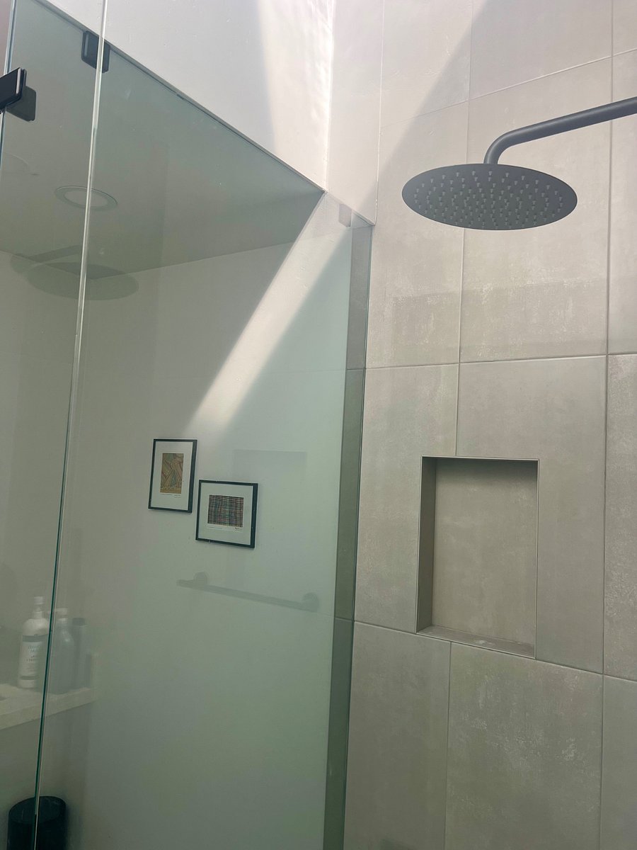 Custom shower with vaulted ceiling and skylight.