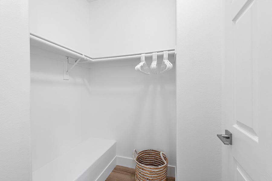 Walk in closet in primary bedroom.