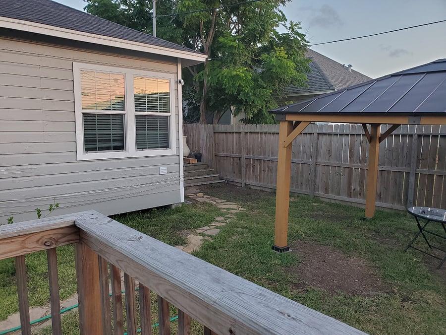 A view from the front porch of the guest cottage. The view is of the main house where we live and of a pavilion.