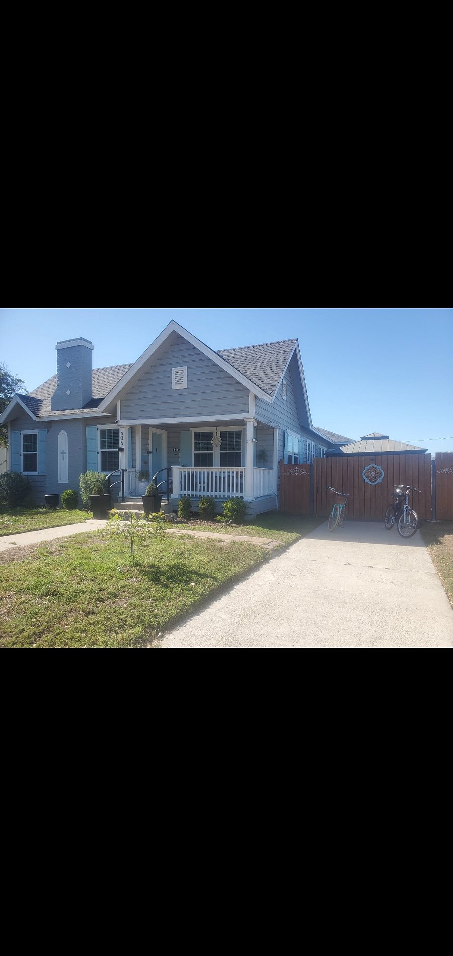 Entry to the back yard is through the pedestrian door to the left of the driveway gate.