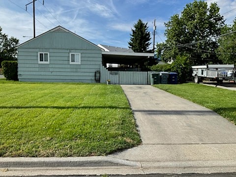 Side-street view of property showing driveway and covered patio
