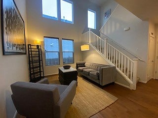 Living room/stairs and vaulted ceilings with a lot of windows and light