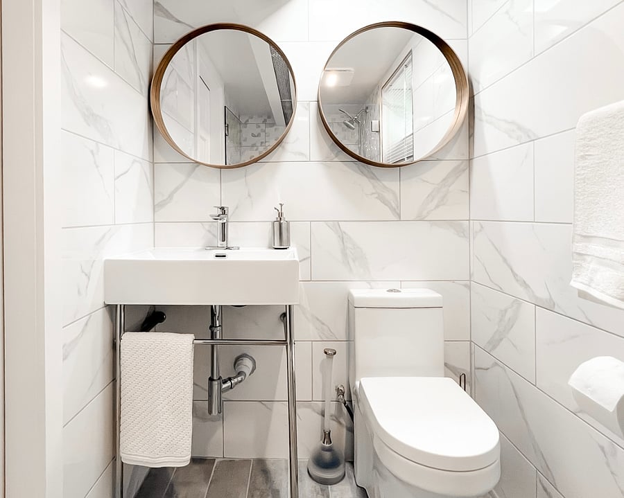 Double Mirrors, Bathroom Sink, and Toilet.