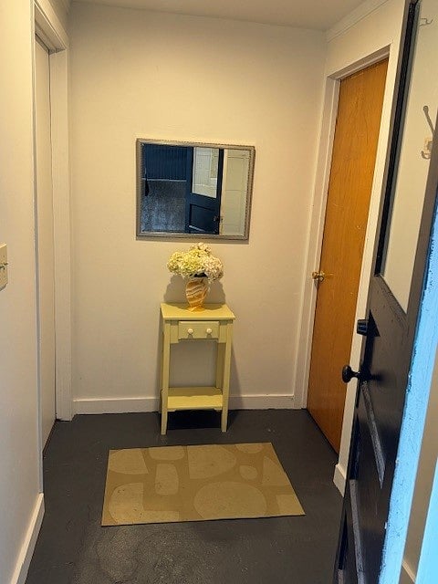Entry foyer with coat rack and room for shoes. To the right is laundry room and storage. To the left is apartment.
