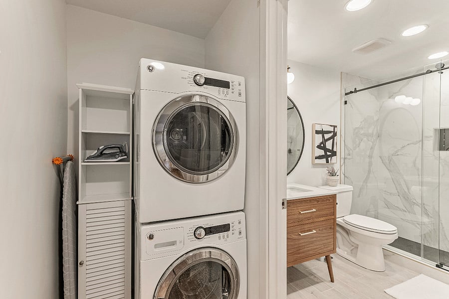 Stackable GE Washer & Dryer. Also large iron board, brand new iron, and cleaning supply storage. 