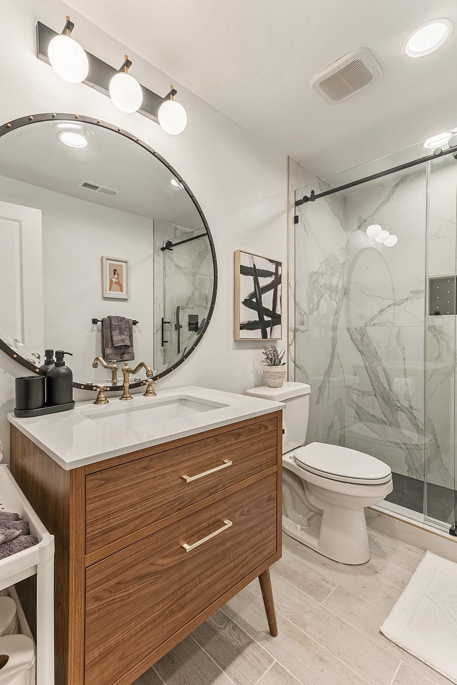 Large tiled shower with glass sliding door for a sleek and efficient look. 