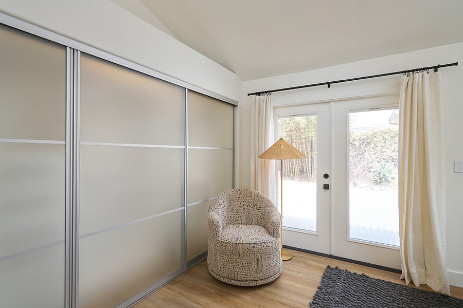 Master closet with sliding glass doors.