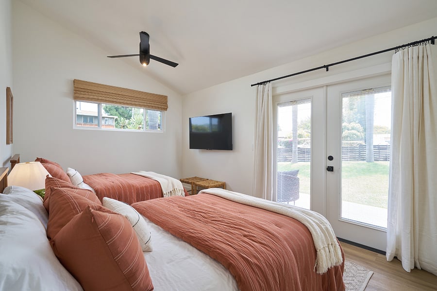 Guest bedroom with 2 full size beds and smart TV.