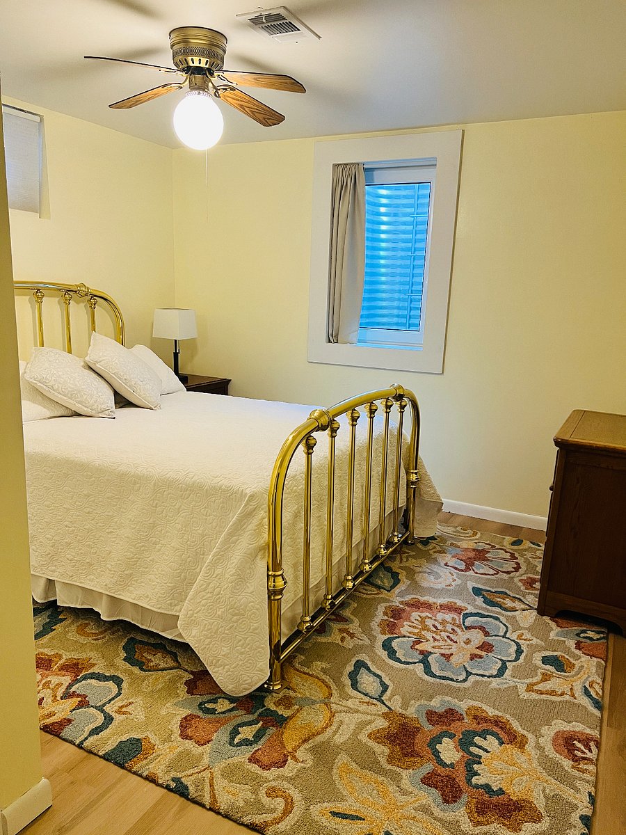 Bedroom with egress window for light and safety. Queen size bed and 3 drawer dresser.
