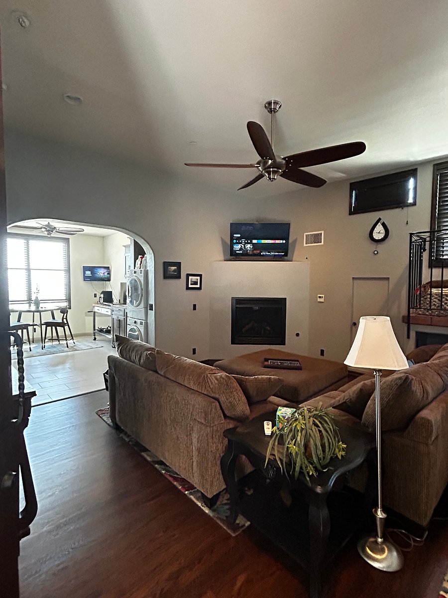 Large living area with smart TV connected to kitchenette.