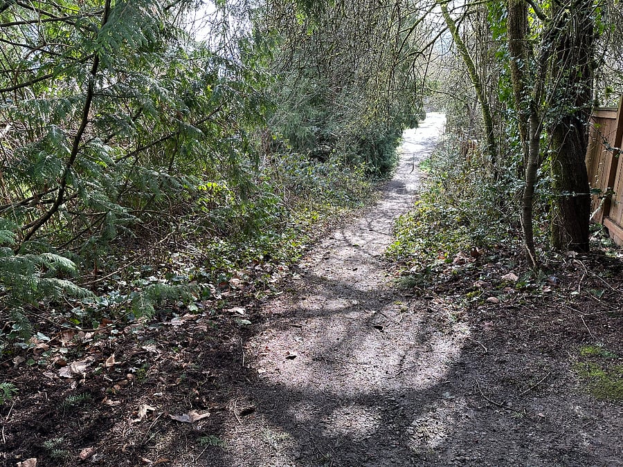 Walking trail behind yard connecting to another neighborhood/street