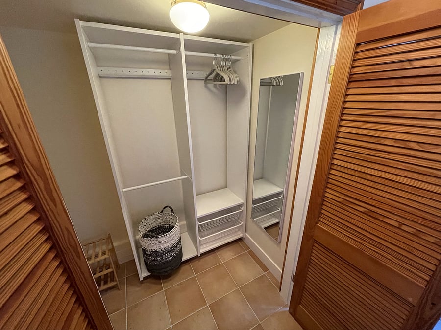 Walk-in closet closer look, standing mirror, small shoe rack, and 3 poles for hanging clothes. Clothes hangers and laundry basket provided. (Now has stacked Washer/Dryer on the right inside)