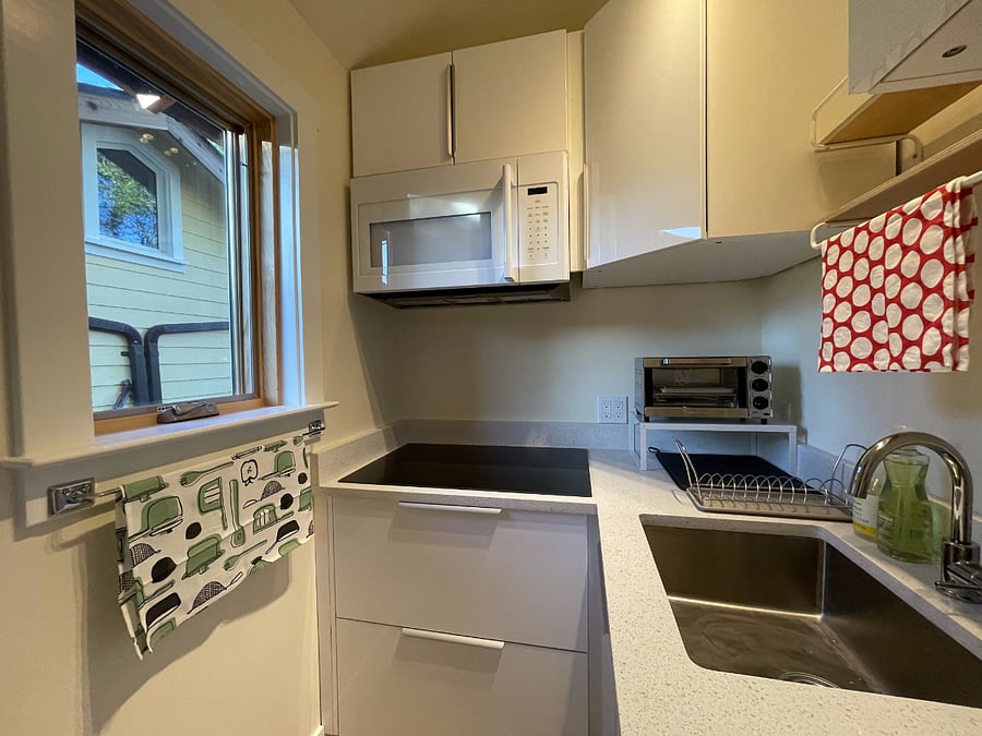 Kitchen perspective from countertop, south-facing kitchen window seen.