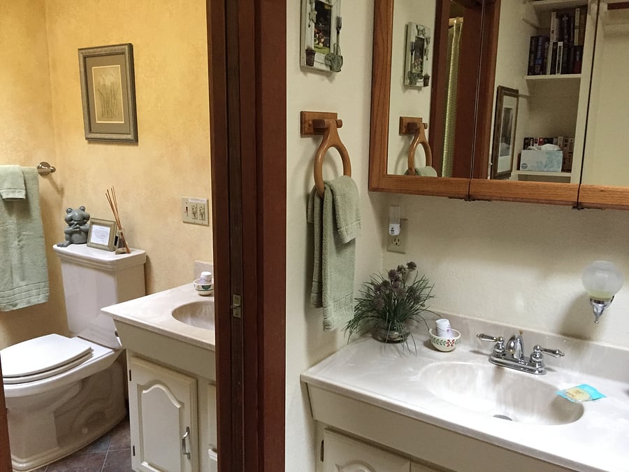 Bathroom has sink, vanity, shower, toilet and storage, with an additional sink and vanity nestled in the walk-in closet, separated by a pocket door.
