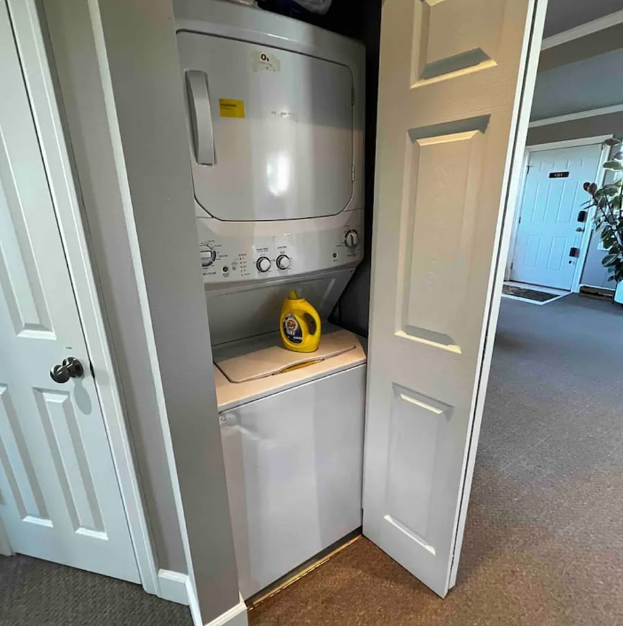 Stackable washer and dryer inside the unit.