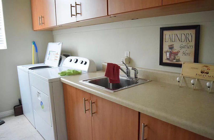 Laundry room with linen closet
