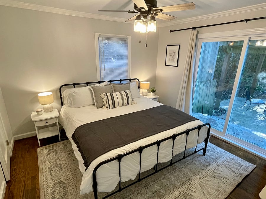 Master bedroom with king sized bed and sliding doors to backyard