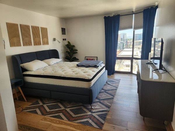 Primary Bedroom with Queen bed, smart TV and view of Union Station.