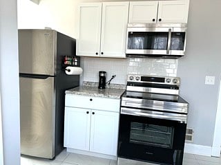 Ktichen- Electric Stove/Full Sized Fridge; Microwave