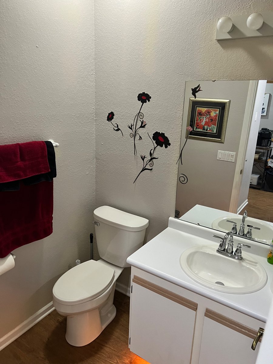 Half bathroom downstairs near entrance.