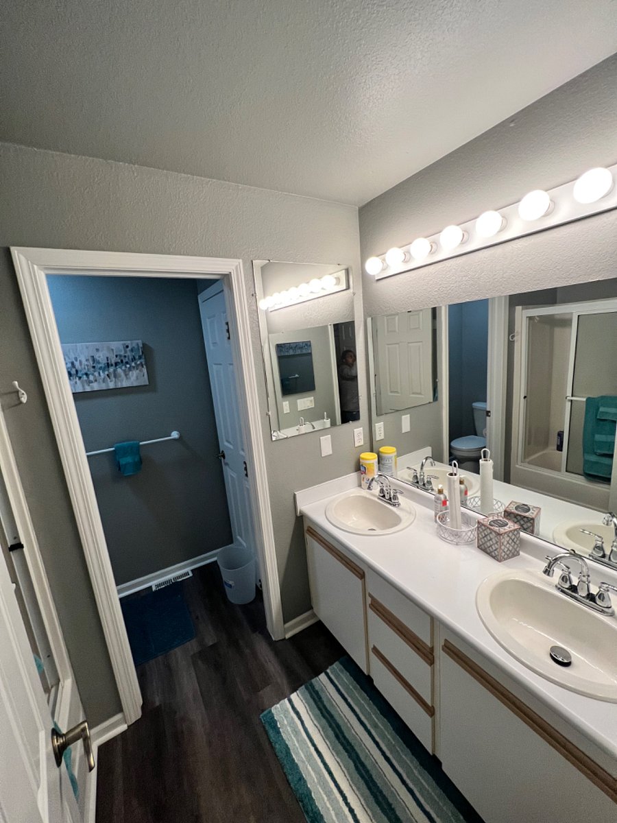 Master bathroom with sliding glass door (tub/shower feature) and separated toilet room.