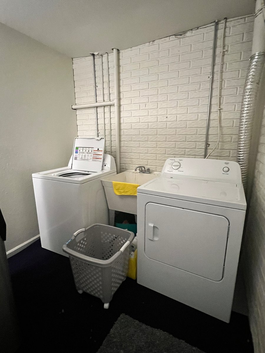 Large laundry room in basement with washer and dryer.