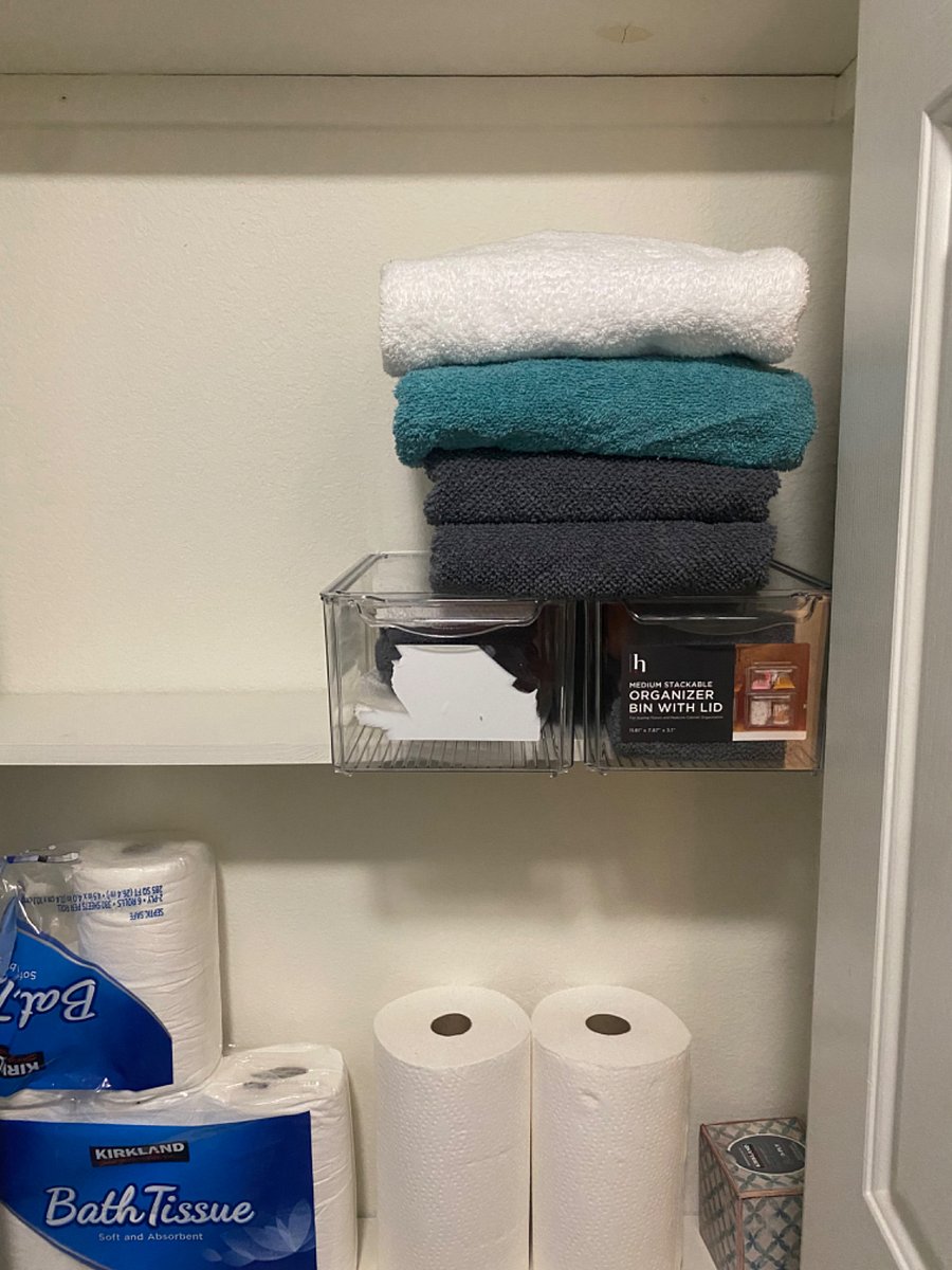 Master linen closet with cleaning supplies and toiletries.