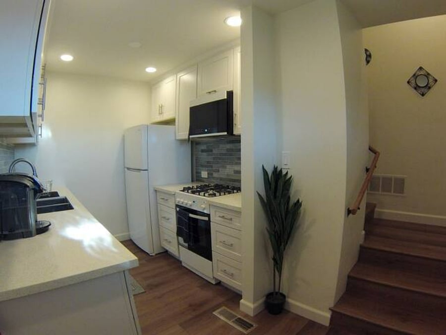 Kitchen located downstairs from mezzanine upper floor.