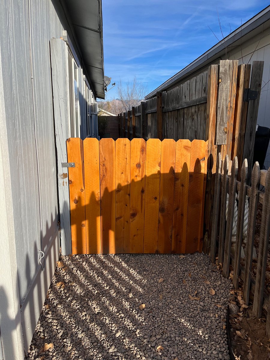Key-locked gate leading from parking space to private entrance on the back patio.