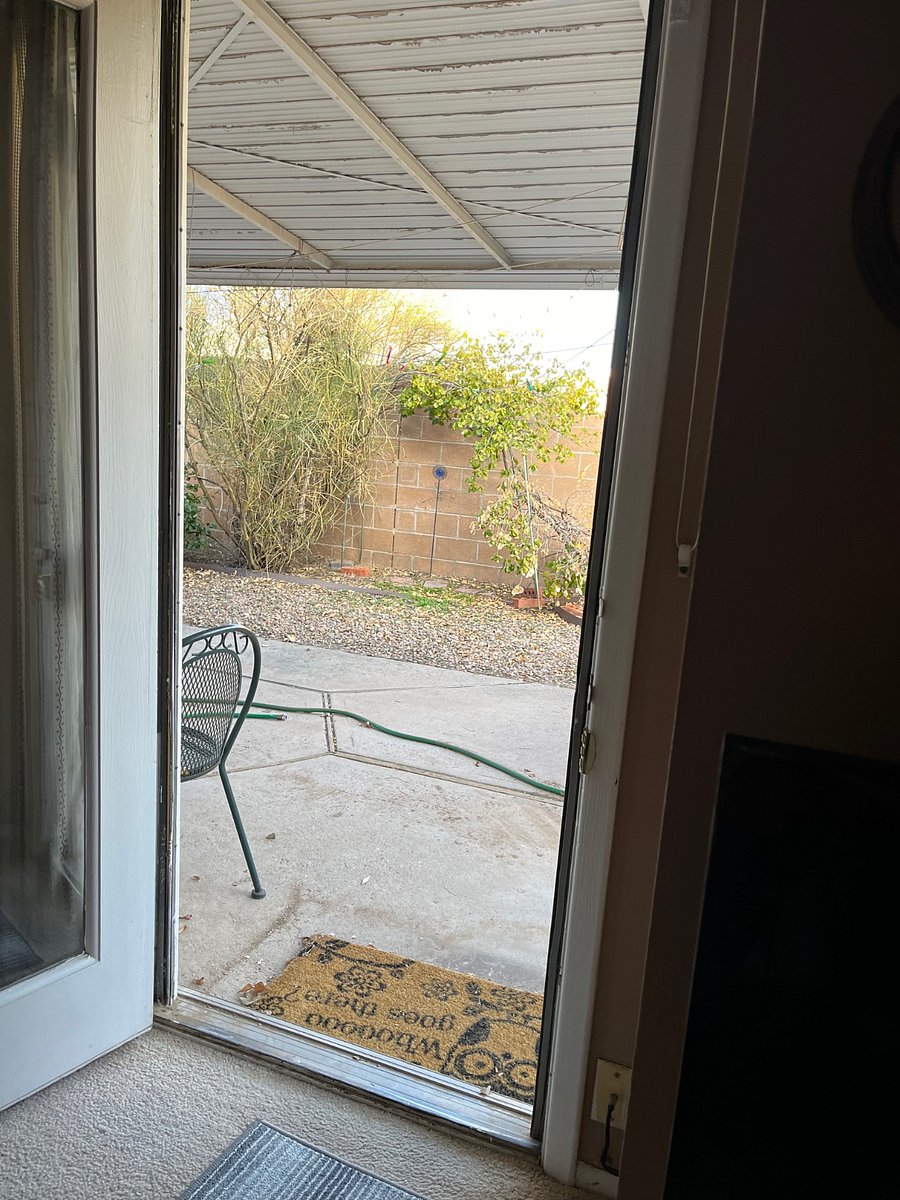 Door to covered patio, very pretty and private in season.