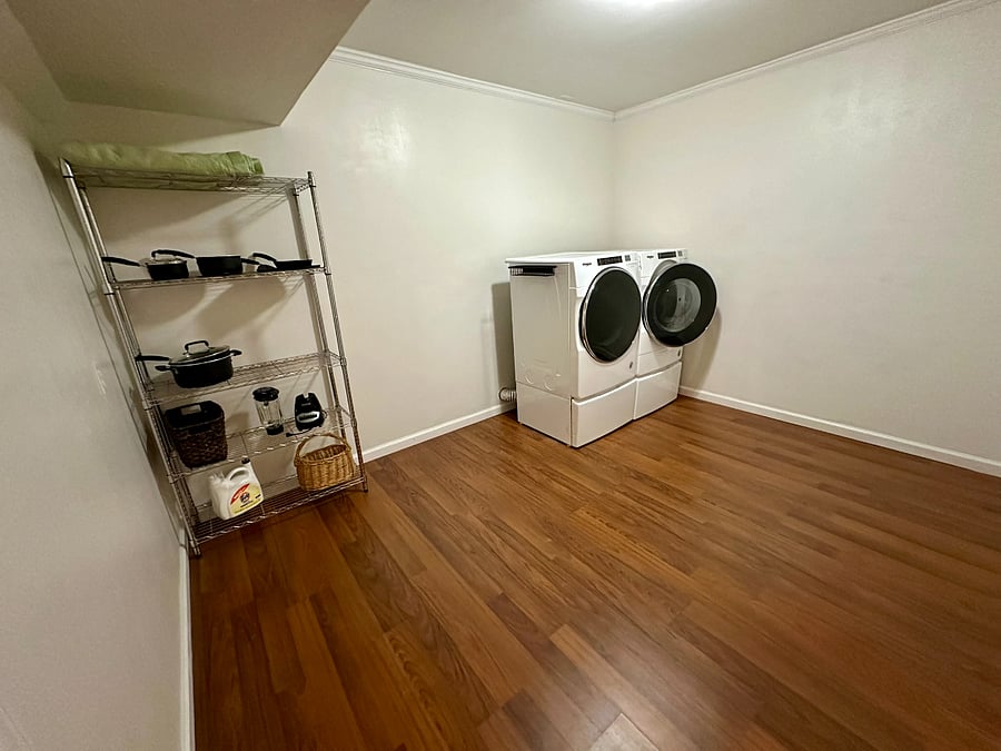 In-unit washer/dryer room with kitchen storage is adjacent to kitchen.