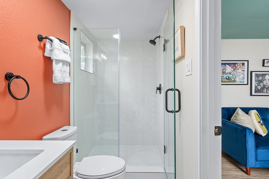 Stand up shower with glass door.