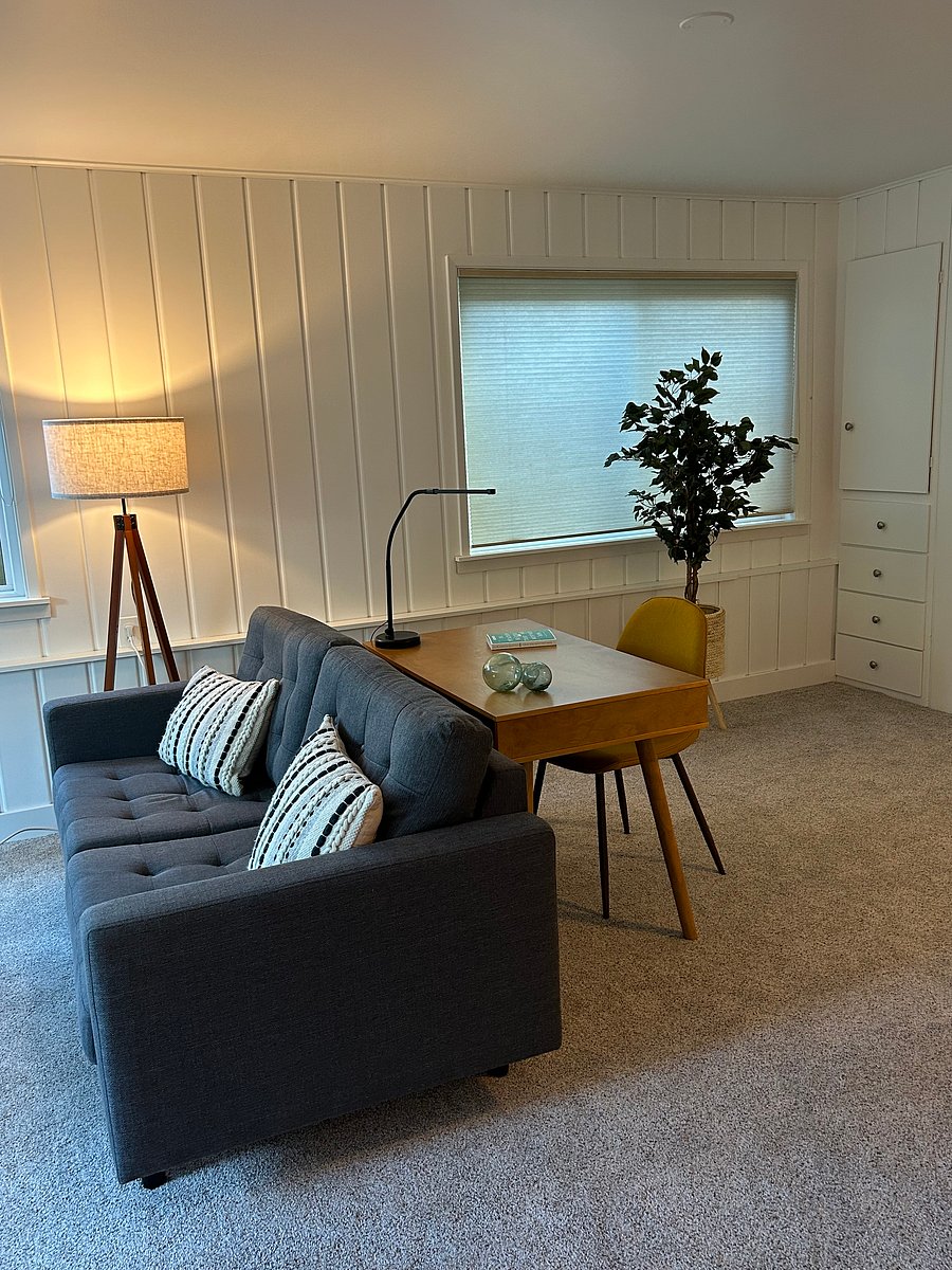 Desk area behind sofa & TV