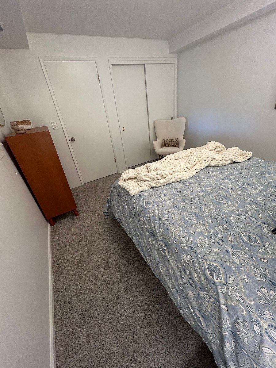 Large closet and side chair with closed door to bedroom