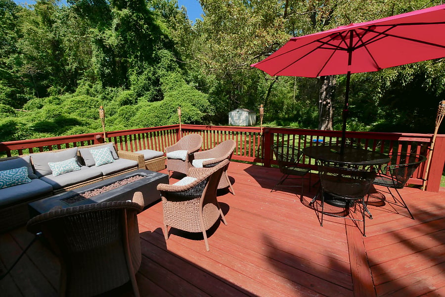 600 sq ft deck with table, chairs, and umbrella. 