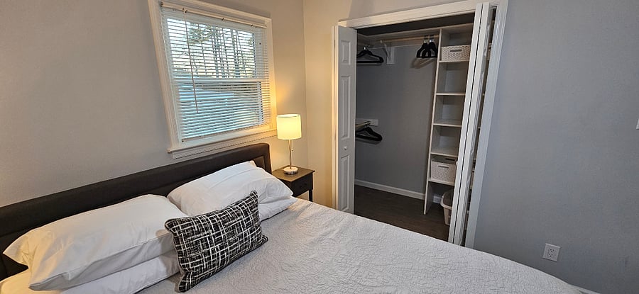 Primary bedroom - with view of custom wood closet