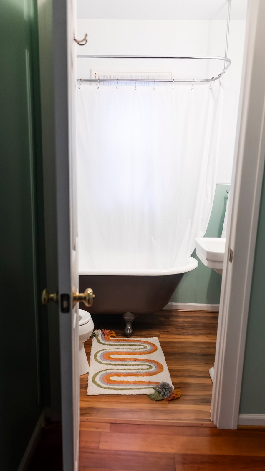 Clawfoot tub & pedestal sink in bathroom.