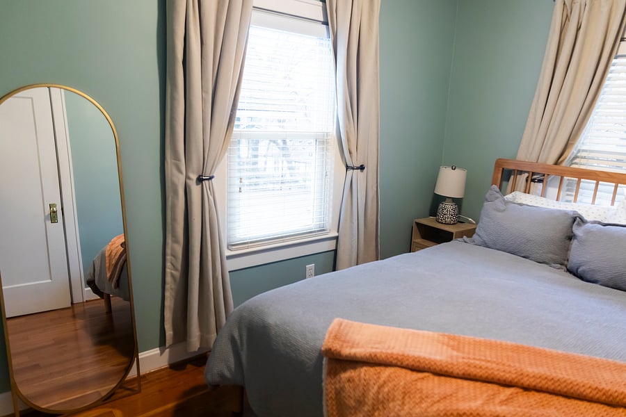 Back bedroom with queen bed & full mirror.