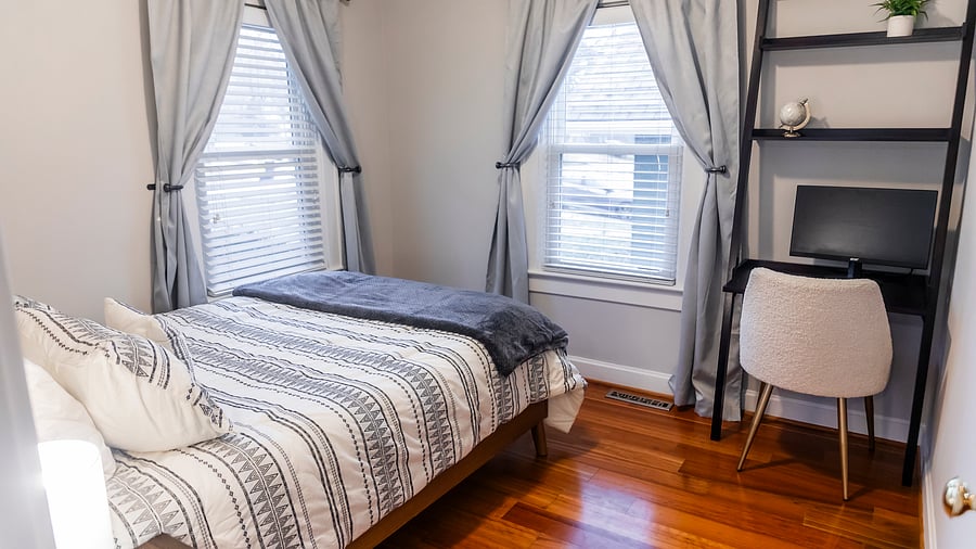 Front bedroom with full bed, desk, & external monitor.