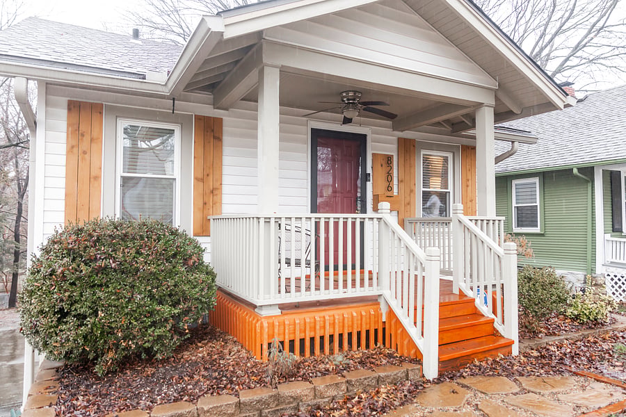 Front porch with chairs and ceiling fan perfect for relaxing.