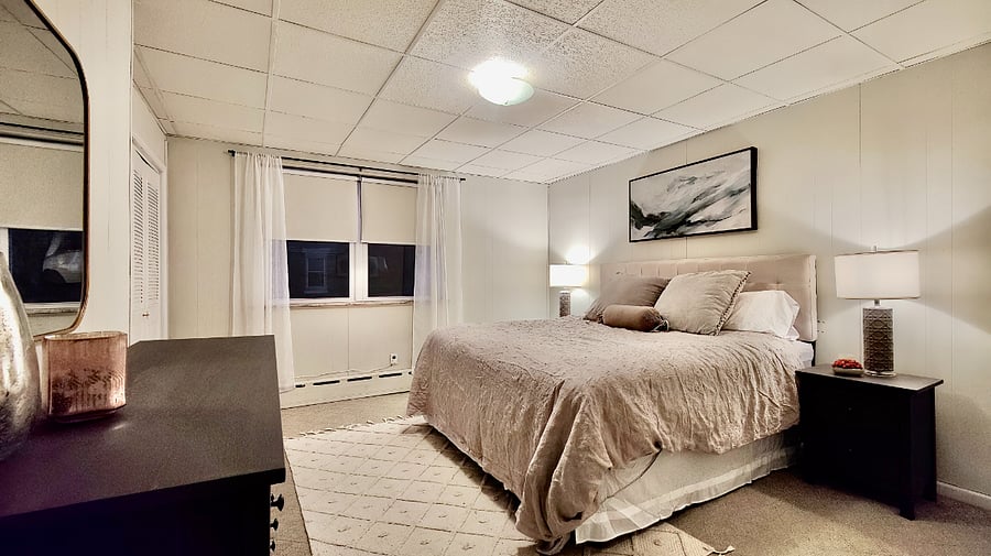 Primary bedroom with king bed, large closet, dresser and 2 night stands