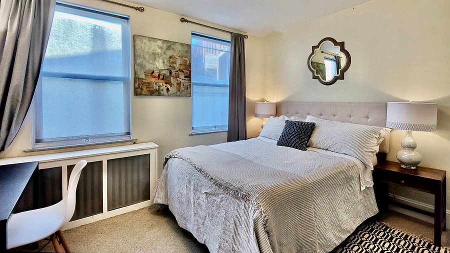 Queen bedroom with desk, dresser and large closet
