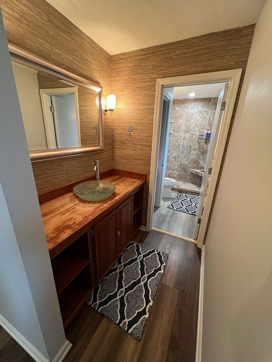 Master Bath. Privacy door closes to separate shower/toilet area. Vanity has ample storage, amazing natural light from 2 windows, and dimmable overhead lights.