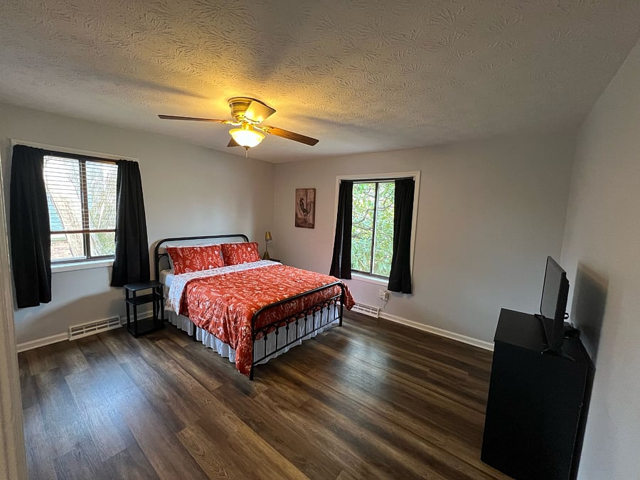 Guest Bedroom #1: two windows for lots of natural light. nightstands on both sides. lamp. Blinds + blackout curtains. Large closet with hanging space and shelves